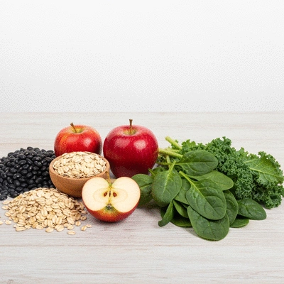 Variety of fiber-rich foods like oats, beans, apples, and leafy greens